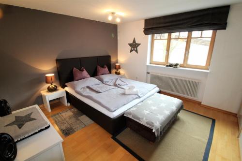 a bedroom with a large bed and a window at Apartment Franz-Walde-Weg by Apartment Managers in Kitzbühel