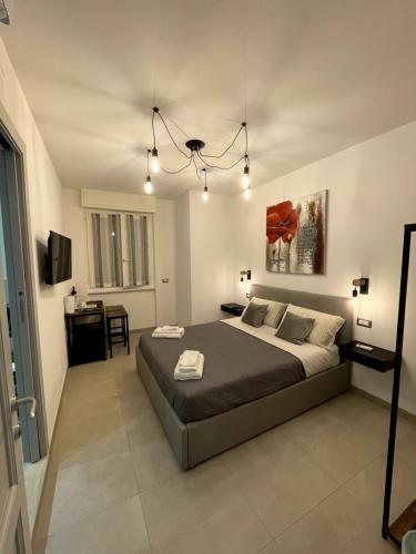 a bedroom with a large bed and a table at Alguer 74 in Alghero