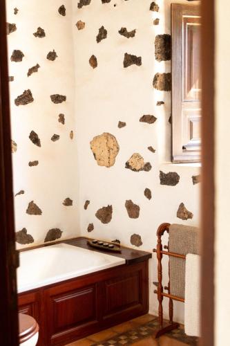 a bathroom with rocks painted on the wall at Joya del Jable in Tao