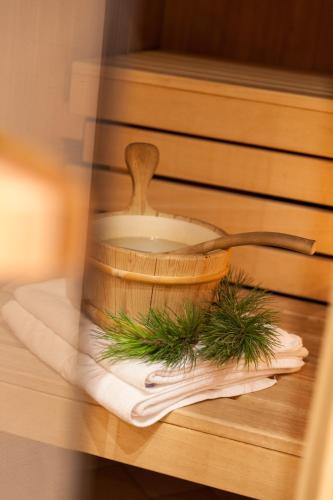 a bowl and a wooden spoon on a table at Alpenspitz Appartements - Garni - B&B in Racines