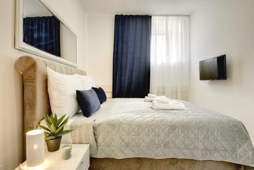 a bedroom with a bed with towels on it at D&A Central Luxury Apartments with FREE Parking in Pula