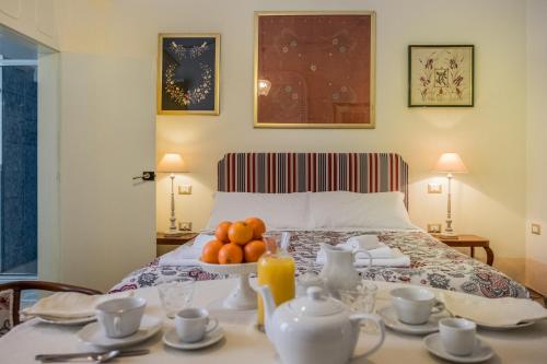 a bedroom with a bed with a table with fruit on it at Palazzo Bernardini Suites in Lecce