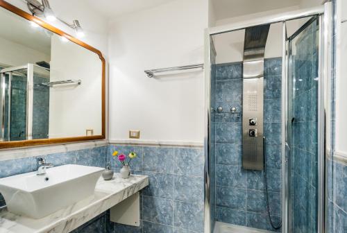 a bathroom with a sink and a shower at Palazzo Bernardini Suites in Lecce
