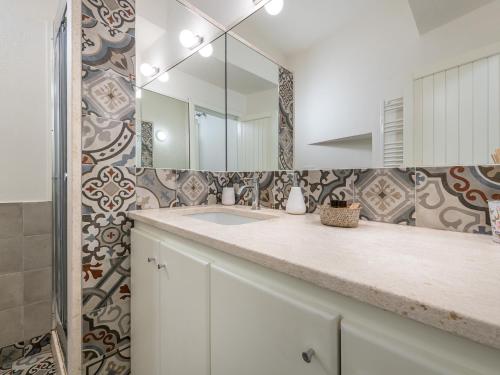 a bathroom with a sink and a mirror at Marco's stylish home In the heart of Cagliari in Cagliari