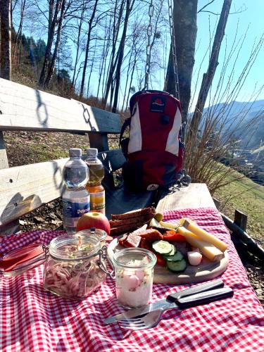 a picnic table with food and a backpack on a bench at Landhotel Hirschen in Oberwolfach