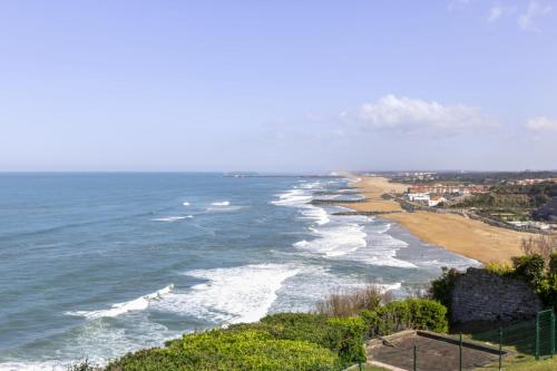 a view of the beach from a bluff at Bright T2 with balcony and sea view in Biarritz in Biarritz