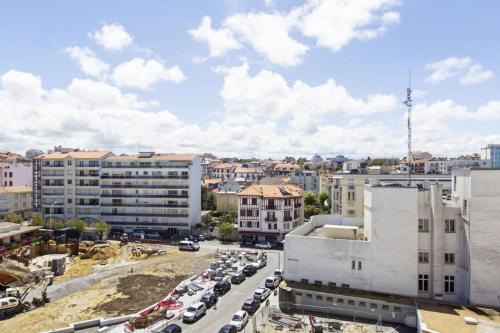 a city with cars parked in a parking lot at Studio Thalmar - Welkeys in Biarritz