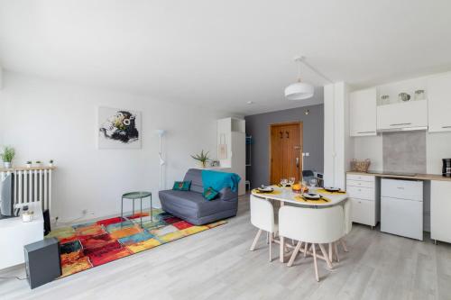 eine Küche und ein Wohnzimmer mit einem Tisch in der Unterkunft Nice studio with balcony and parking in Villeurbanne near Lyon - Welkeys in Villeurbanne