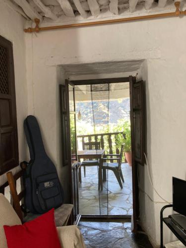 a living room with a door open to a patio at Casa Barbara in Ferreirola