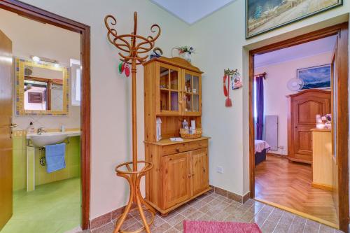 a bathroom with a sink and a wooden cabinet at Apartment Goga - Seaview & Parking in Mali Lošinj