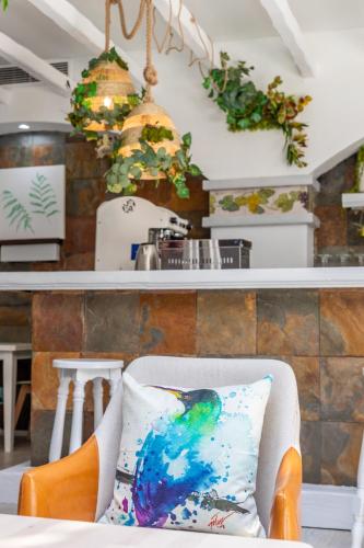 a chair with a pillow on it in a kitchen at Hotel Marhava in Conil de la Frontera
