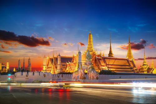 a night view of a building with a street in front at Grand China Bangkok in Bangkok