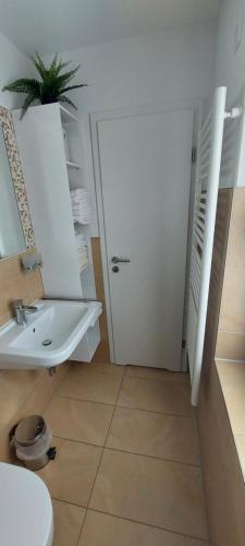 a bathroom with a white sink and a toilet at Appartements am Schillergarten in Dresden