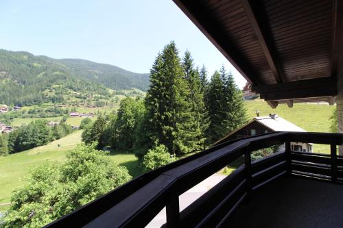 a balcony of a house with a view of the mountains at Bad Kleinkirchheim RMG family apartments in Bad Kleinkirchheim