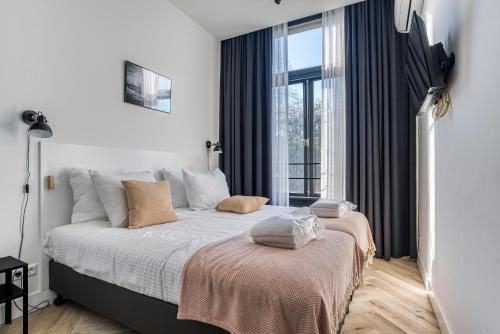 a bedroom with a large bed and a window at Hosted by Wendy prins willem 2 in Scheveningen