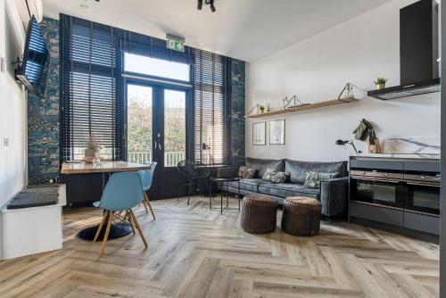 a living room with a couch and a table at Hosted by Wendy prins willem 2 in Scheveningen