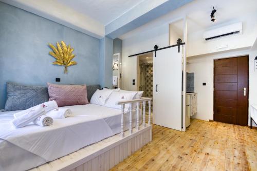 a bedroom with a large white bed and blue walls at Bastion Luxury Medieval Accommodation in Rhodes Town