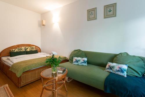 een kamer met een bank, een bed en een tafel bij Negroni Apartments Stare Miasto in Krakau