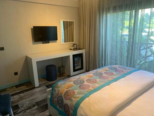 En eller flere senge i et værelse på Villa Oliva Butik Hotel