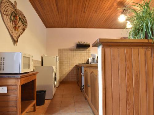 a kitchen with a microwave and a refrigerator at Scenic Home in Berbiguières in Saint-Germain-de-Belvès