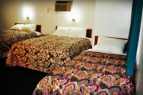 a hotel room with two beds in a room at Town House Motel in Rapid City