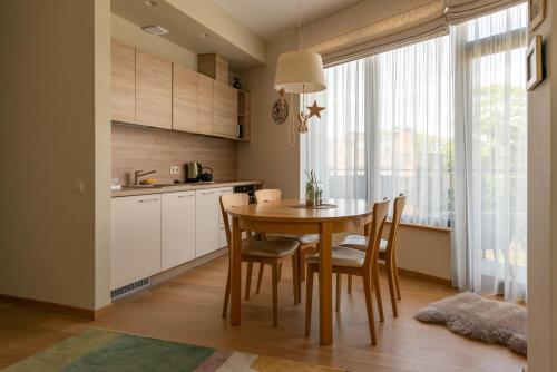 a kitchen with a table and chairs in a room at 39DO in Druskininkai