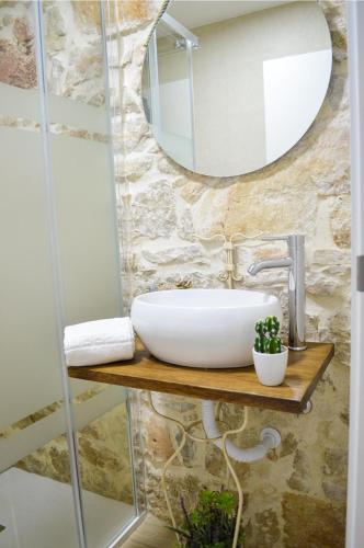a bathroom with a sink and a mirror at Casa GANCHINHO in Santiago da Guarda