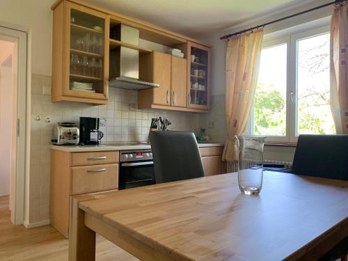 a kitchen with a wooden table with a glass on it at Casa Mika in Konstanz