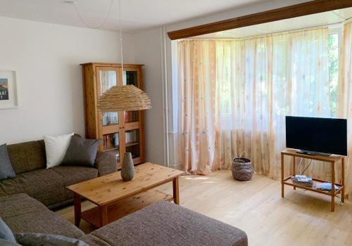 a living room with a couch and a tv at Casa Mika in Konstanz