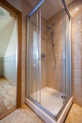 a shower with a glass door in a bathroom at Liepas in Ventspils