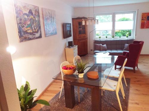 a dining room and living room with a table and chairs at Ferienwohnung Am Michelsbach in Boppard