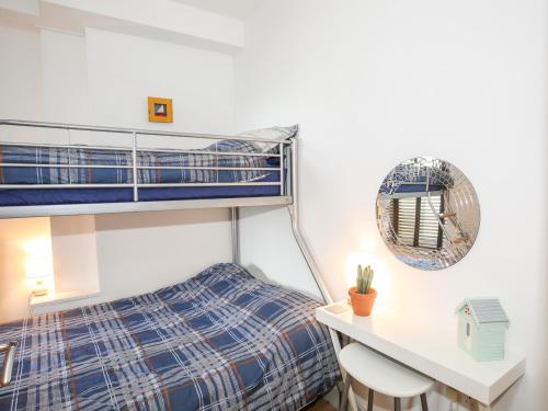 a bedroom with a bunk bed and a desk at Gwel Y Mor in Pwllheli
