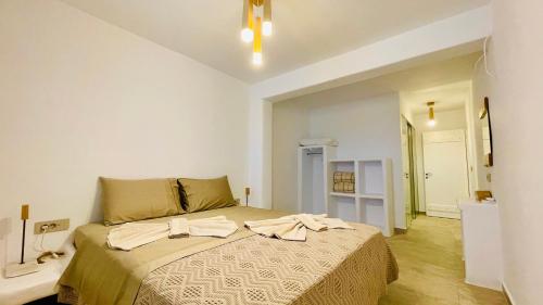 a bedroom with a large bed in a room at Aeris suites pori semi basement villa in Koufonisia
