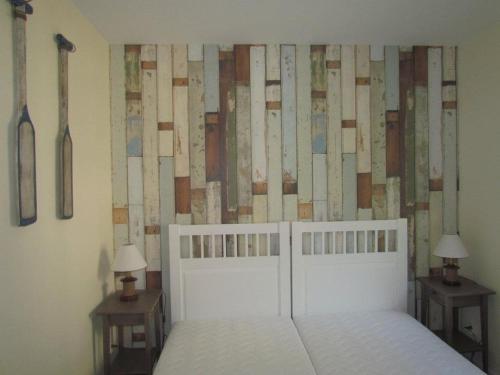 a bedroom with a bed and two tables with lamps at Apartament Korab in Żarnowska