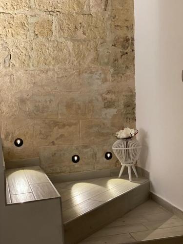a room with a bench and a stone wall at B&B Casa AMALIA in Barletta