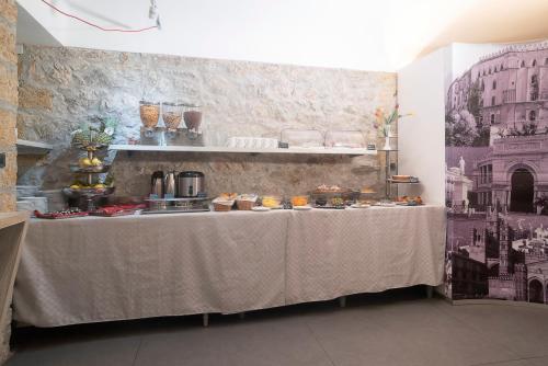 a table with food on it in a room at Hotel Tonic in Palermo