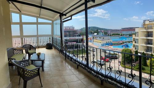 a balcony with chairs and a view of a pool at Guest House Ivano in Primorsko