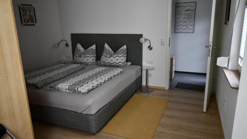 a bedroom with a large bed with a headboard at Gästehaus Steuer in Bruttig-Fankel