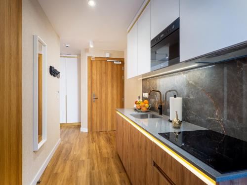 a kitchen with a sink and a counter top at Aparthotel Góralski Spa 2 in Białka Tatrzanska