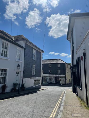 an empty street in a town with buildings at Brownston Apartments in Modbury