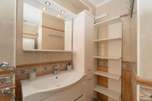 a bathroom with a sink and a mirror at Apartments Galerija in Korčula