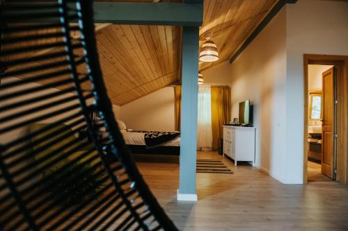 a room with a bed and a staircase at Cabana Fantanele in Ceahlău