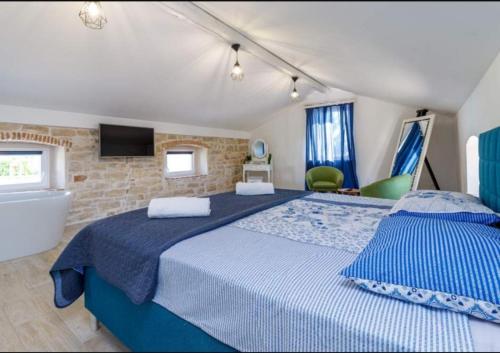 a bedroom with a bed and a tub and a television at Pepe&Lynn in Višnjan
