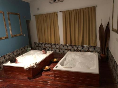 two children laying in two tubs in a bathroom at Hacienda Don Justo Hotel Boutique Spa in Colón