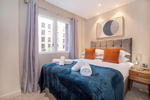 a bedroom with a large bed with towels on it at Hudson Quarter Luxury Apartments in York