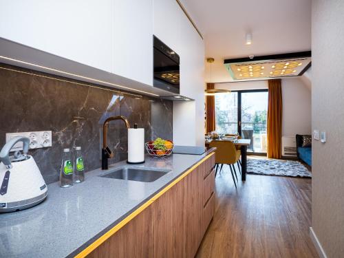 a kitchen with a sink and a counter top at Aparthotel Góralski Spa 2 in Białka Tatrzanska