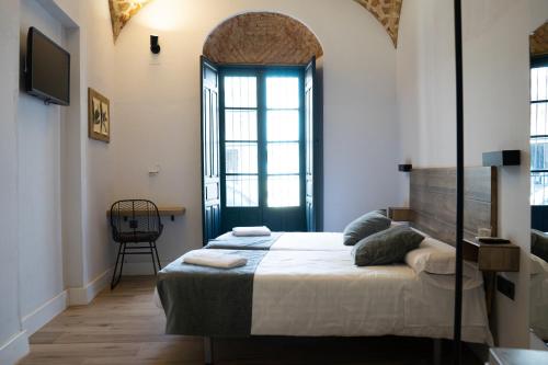a bedroom with a bed and a tv in a room at Balhondo Open Village in Puebla de Alcocer