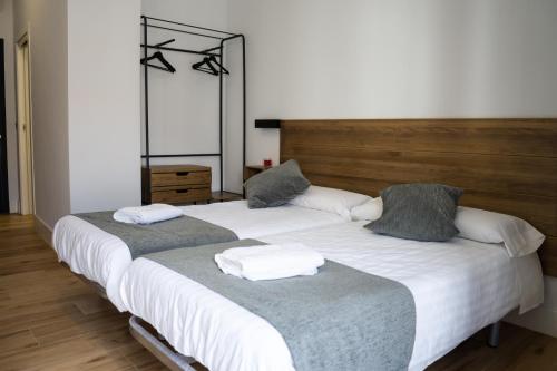 two beds sitting next to each other in a room at Balhondo Open Village in Puebla de Alcocer