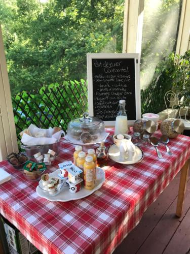 a picnic table with food on a plaid table cloth at Domaine de la Baie, Les Suites in Shawinigan