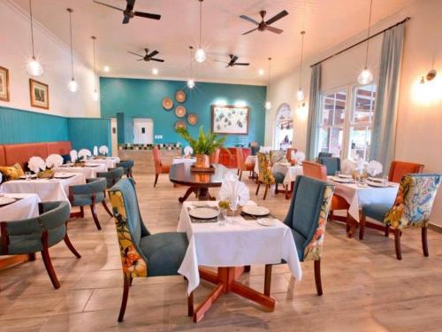 a dining room with tables and chairs in a restaurant at Pioneers in Victoria Falls